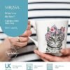 A person holds the 380ml Fine China Cat Mug, showcasing an illustrated feline in a floral headscarf. This charming accessory, designed in the UK, is both dishwasher and microwave-safe, combining practicality with elegance.