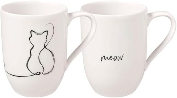 The Cat Mug Set, 280 ml (2 Pieces), includes two delightful white ceramic mugs with minimalist designs: one displays a black outline of a sitting cat, while the other is adorned with the word "meow" in lowercase script. Both mugs have large handles for comfortable gripping.