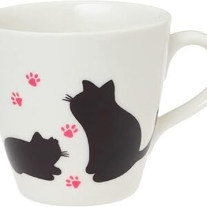 This Colour Changing Mug displays black silhouettes of two cats, one sitting and the other lying down, surrounded by scattered pink paw prints. The design magically transforms with heat! It also includes a right-side handle for your convenience.