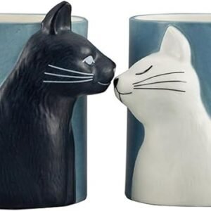 Two 330 ml mugs in blue, each with a handle and delightful 3D cat head designs. One mug features a playful black cat, while the other showcases a charming white cat, both positioned as if they're kissing. Delicate heart patterns accompany the enchanting black and white cats on these whimsical Black Cat and White Cat Mugs.