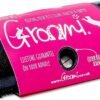 The Coat Shedding Comb, highlighted with a pink label adorned with dog silhouettes and the brand name "Groomi," promises features such as a "quick release screw" and a "lifetime guarantee on your handle." This black tool, featuring a metal component, is ideal for shedding and maintaining your pet's coat sleek and healthy.