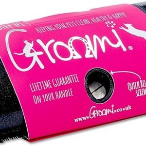 The Coat Shedding Comb, highlighted with a pink label adorned with dog silhouettes and the brand name "Groomi," promises features such as a "quick release screw" and a "lifetime guarantee on your handle." This black tool, featuring a metal component, is ideal for shedding and maintaining your pet's coat sleek and healthy.