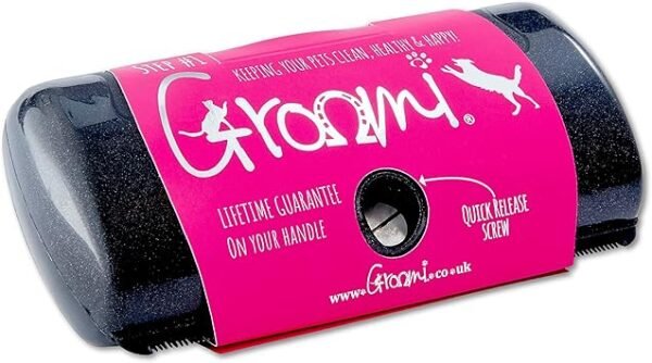 The Coat Shedding Comb, highlighted with a pink label adorned with dog silhouettes and the brand name "Groomi," promises features such as a "quick release screw" and a "lifetime guarantee on your handle." This black tool, featuring a metal component, is ideal for shedding and maintaining your pet's coat sleek and healthy.